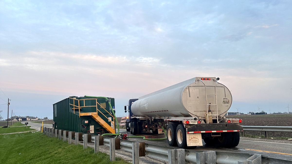 Bulk water delivery truck filling a tank - Cabin Creek Water Transport